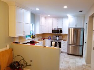 kitchen renovation with white cabinets and quartz countertops underway