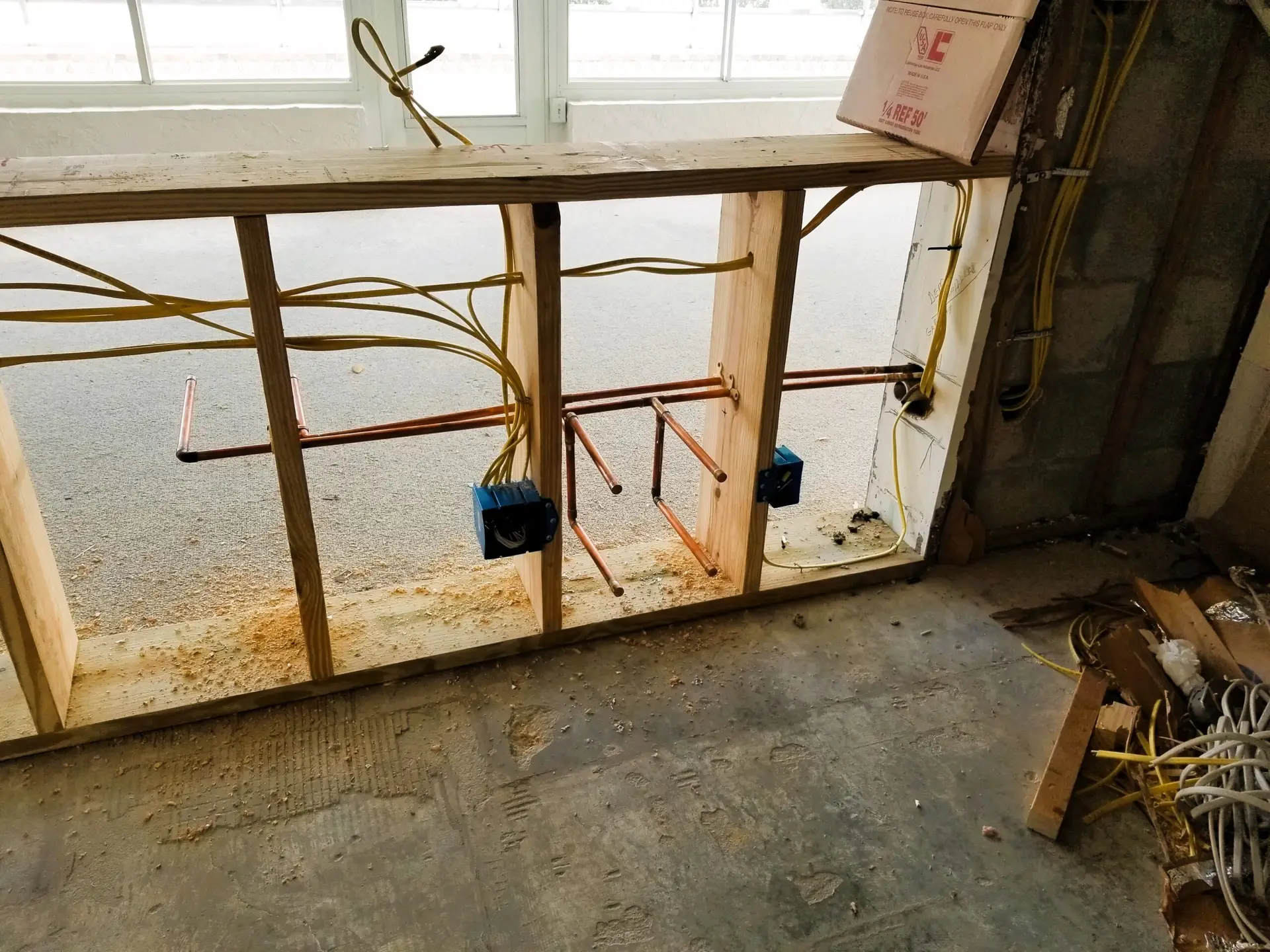 working on the rough in plumbing and electrical wiring for a new kitchen layout