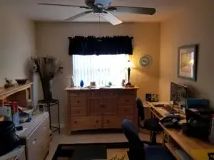 Before photo of spare bedroom with mismatched furniture in Palmetto FL home