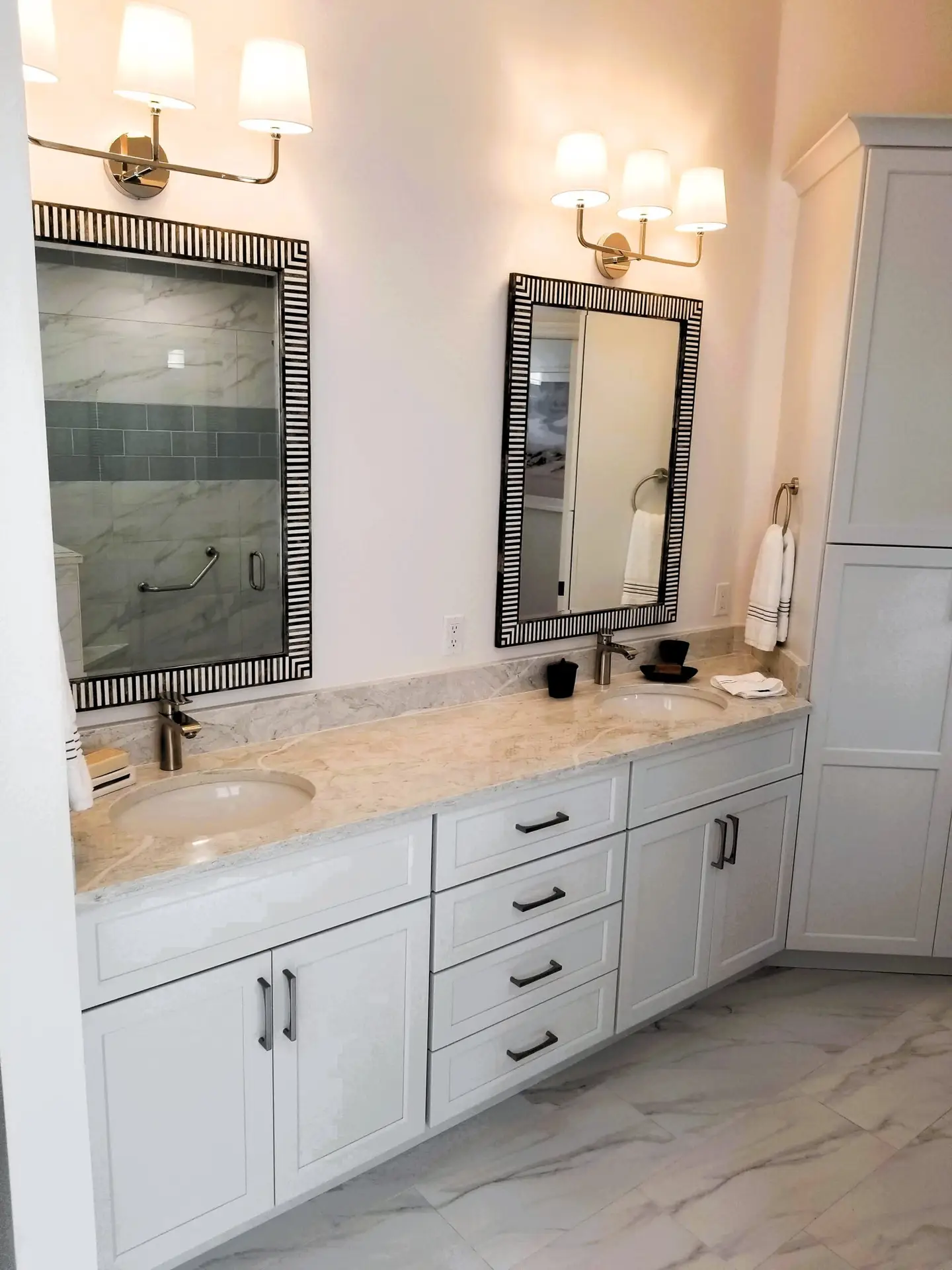 Bradenton master bathroom remodel with white StarMark vanity and framed mirrors