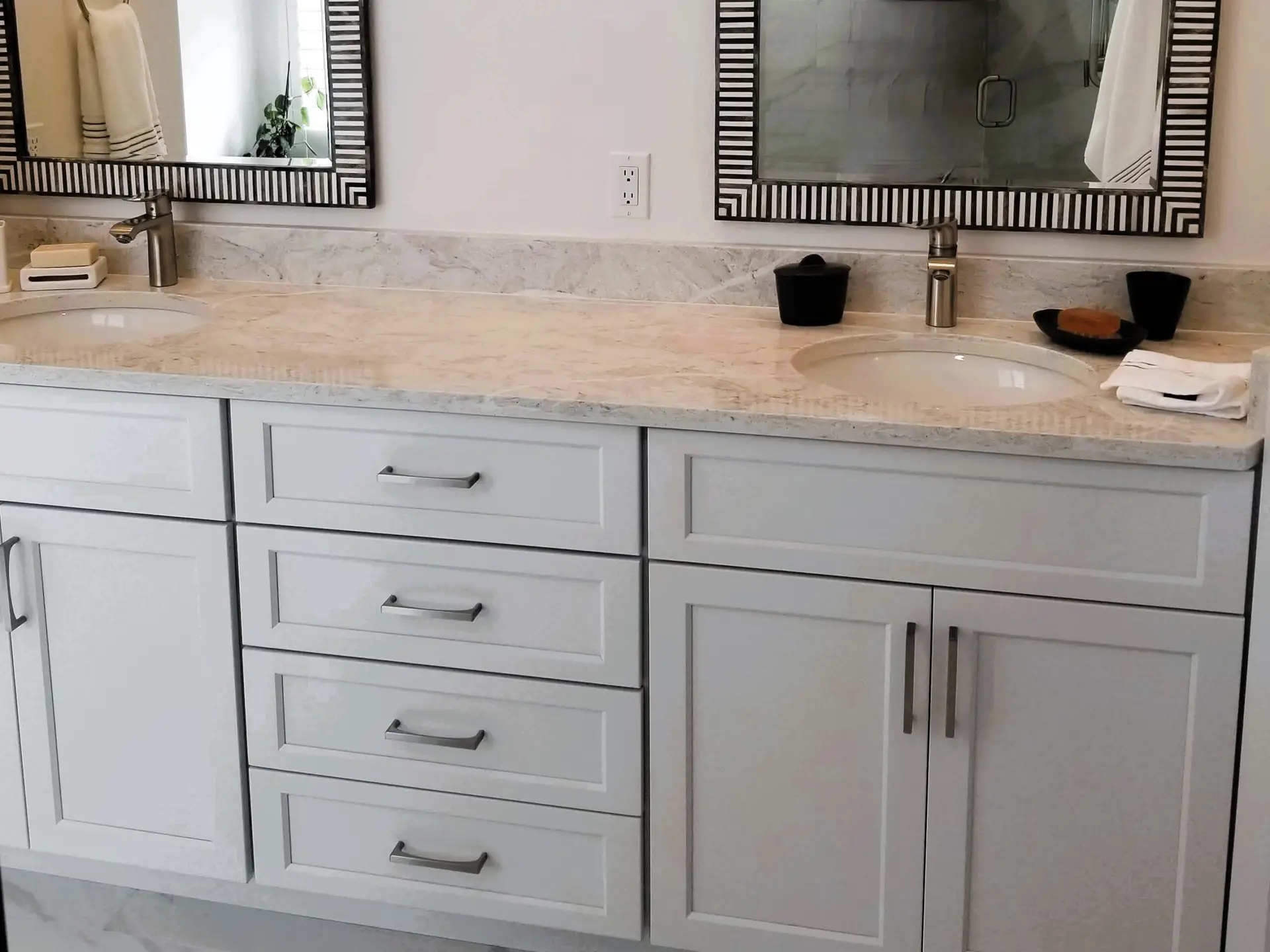 Double sink vanity with StarMark cabinetry and framed mirrors