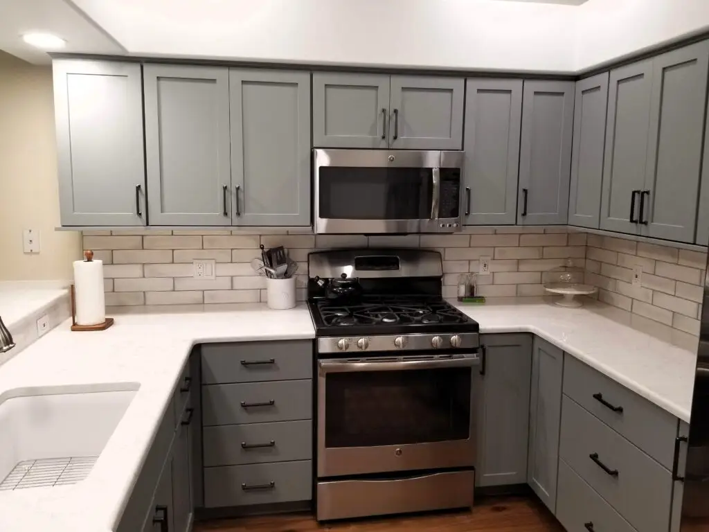 Shale gray StarMark cabinets with weathered subway tile backsplash