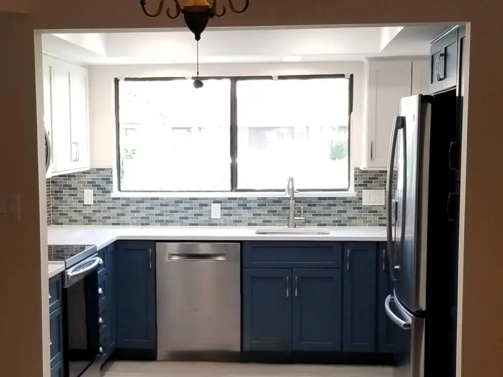 Bradenton kitchen remodel showing a wide, open entryway into a blue and white kitchen