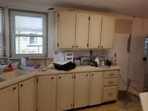 Dated, beige mobile home kitchen before remodel in Colony Cove, Ellenton FL