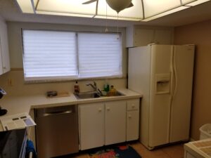 Dated domed ceiling and cramped floorplan in this Meadowcroft condo kitchen before remodeling