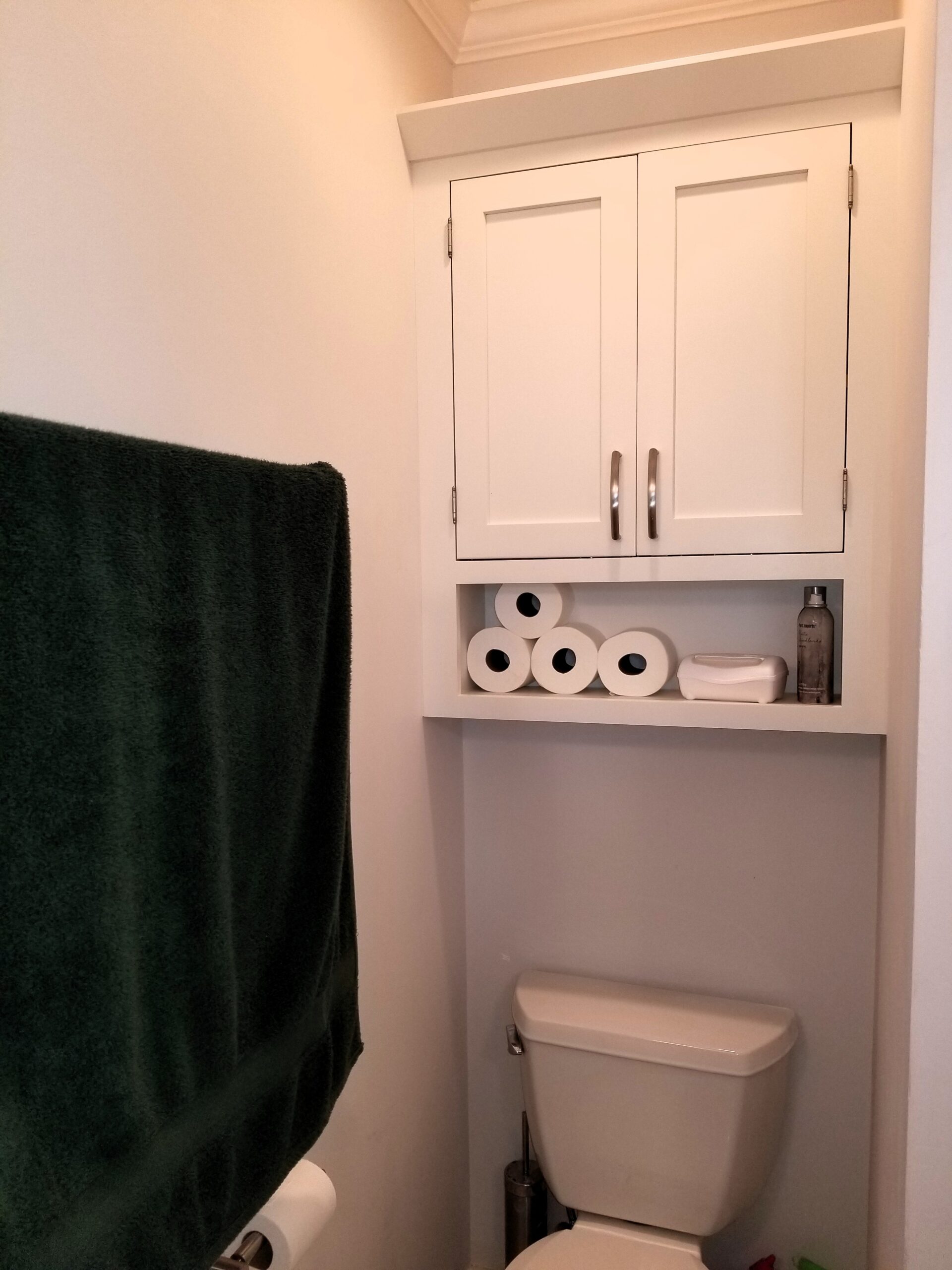 Inset cabinetry with finial hinges and open shelf storage