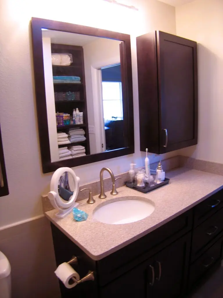 Tall vanity with Cambria quartz and framed mirror in Bradenton bathroom