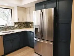 a kitchen pantry and refrigerator area, showcasing a new dark blue tall pantry with roll out trays