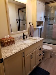 Bradenton bathroom remodel featuring StarMark cabinetry in Mushroom finish and corner storage cabinets