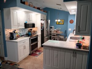 oastal kitchen remodel in Palmetto featuring white StarMark cabinetry and blue walls