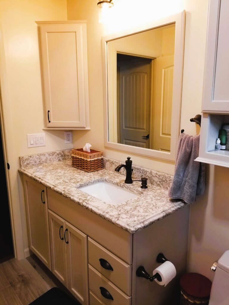 Hall bathroom vanity with asymmetrical sink, corner medicine cabinet, and Cambria quartz countertop