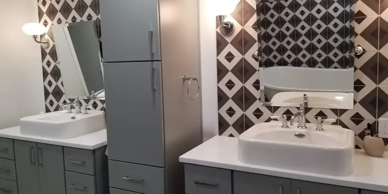 master bathroom remodel near Bradenton, Florida, with geometric tile walls, gray cabinetry, and white countertops