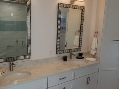 two sink bathroom vanity cabinet with linen cabinet and decorative mirrors. Part of a custom bathroom remodel in Bradenton, Florida