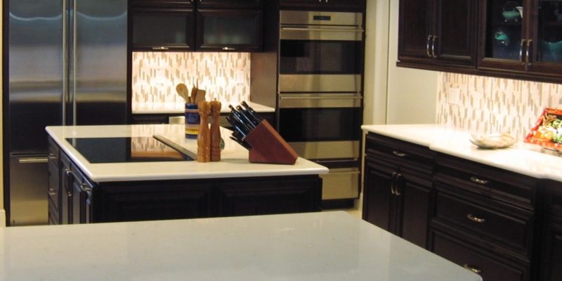 Modern kitchen remodel with elegant wood finish cabinets and quartz countertops by Duncan's Creative Kitchens