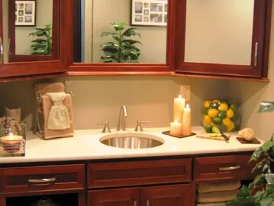 Custom cherry bathroom vanity cabinet with two corner medicine cabinets and matching framed mirror. Part of a bathroom remodel in Bradenton, Florida