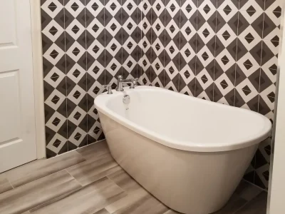 vessel tub with geometric tile walls featured prominently in a master bathroom remodel in Palmetto, Florida